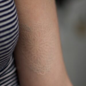 Healed white tattoo.